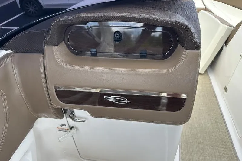 Slide: The Image of 2015 Chaparral 257 SSX boat interior with brown leather and wood accents. - 20