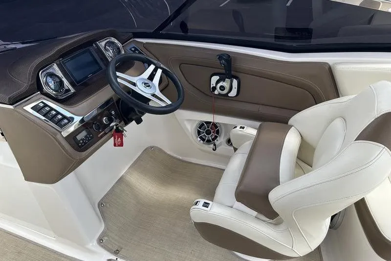 Slide: The Image of Interior cockpit of 2015 Chaparral 257 SSX boat with steering wheel and controls. - 21