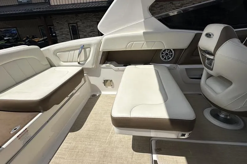 Slide: The Image of 2015 Chaparral 257 SSX boat interior with white and brown seating. - 22