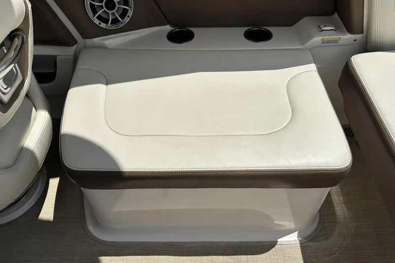 Slide: The Image of 2015 Chaparral 257 SSX boat interior with beige seating and cup holders. - 25