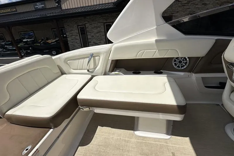 Slide: The Image of 2015 Chaparral 257 SSX boat interior with beige seating and speaker system. - 30