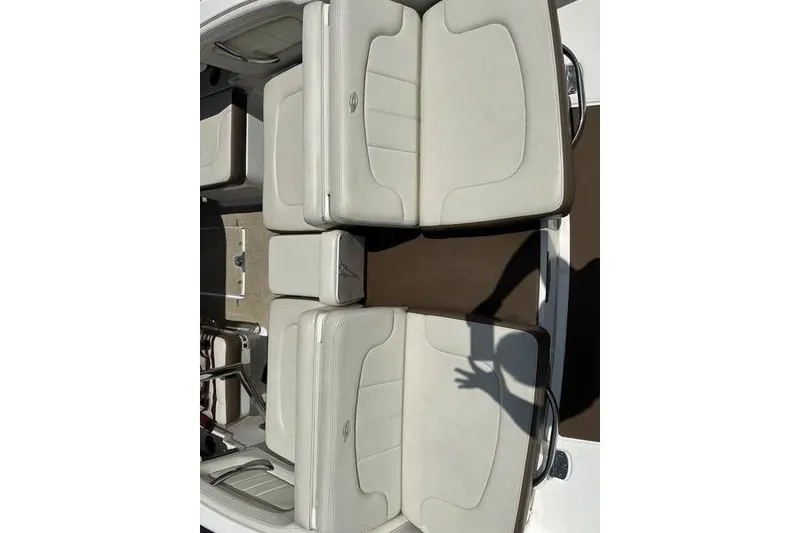 Slide: The Image of 2015 Chaparral 257 SSX boat interior with white cushioned seating and brown flooring. - 32