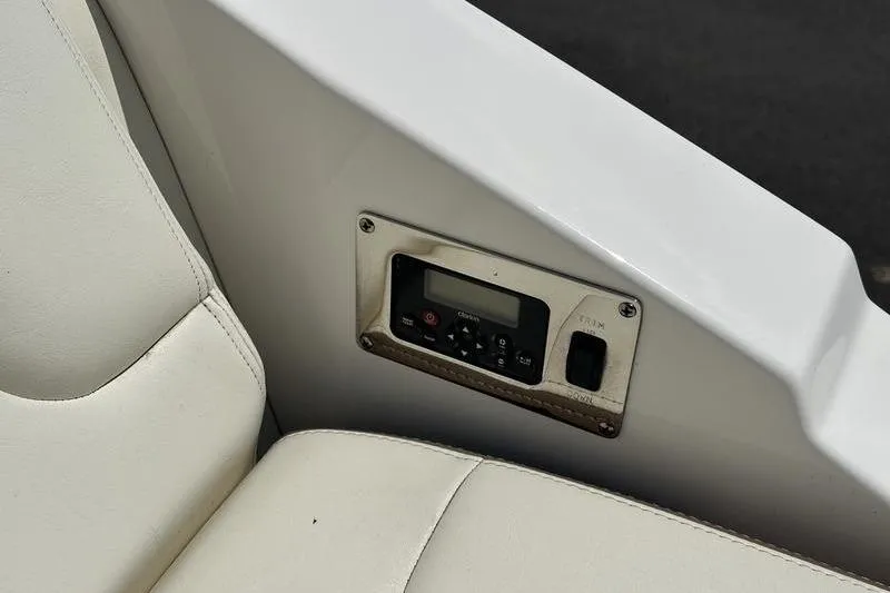 Slide: The Image of Control panel on a 2015 Chaparral 257 SSX boat with white seating. - 37