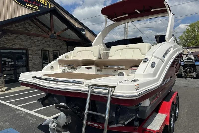 Slide: The Image of 2015 Chaparral 257 SSX boat on trailer, parked outside a marine dealership. - 40