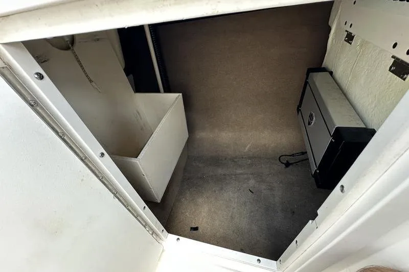 Slide: The Image of Storage compartment inside a 2015 Chaparral 257 SSX boat, featuring a secure lockbox. - 42