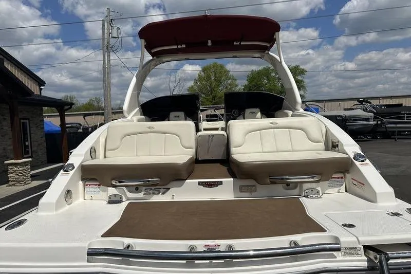 Slide: The Image of 2015 Chaparral 257 SSX boat with spacious seating and sleek design, docked outdoors. - 43