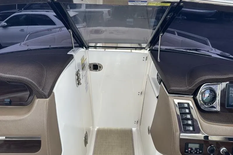 Slide: The Image of Interior view of a 2015 Chaparral 257 SSX boat cockpit with dashboard controls. - 7