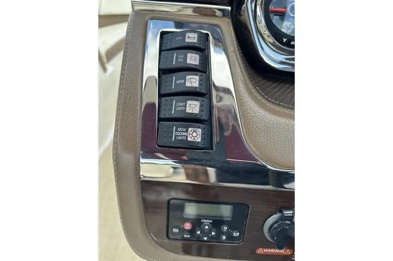 Slide: The Image of Control panel of a 2015 Chaparral 257 SSX boat with various switches and dials. - 9