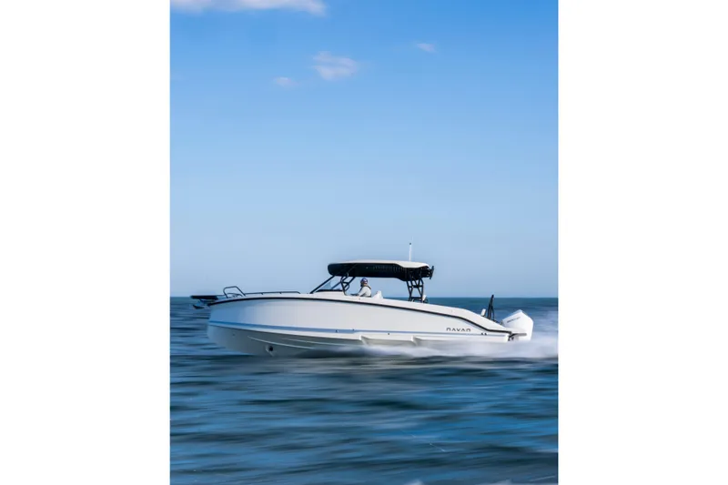 Slide: The Image of Navan T30 2027 boat cruising on open water under a clear blue sky. - 1
