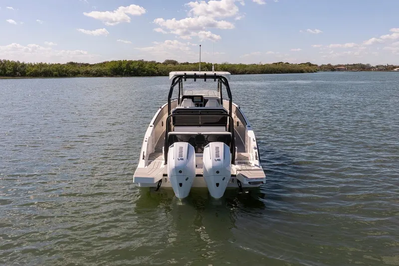 Slide: The Image of Navan T30 2027 boat with dual engines on calm water under blue sky. - 6
