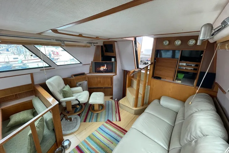 Slide: The Image of Interior of 1987 Sea Ray 410 Aft Cabin with cozy seating and nautical decor. - 4