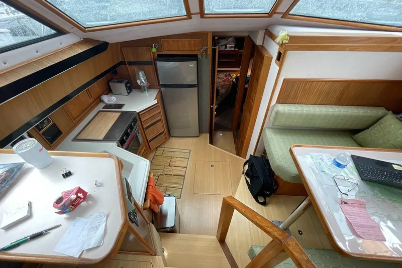 Slide: The Image of Interior of 1987 Sea Ray 410 Aft Cabin with kitchen and seating area. - 5