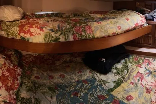 Slide: The Image of 1987 Sea Ray 410 Aft Cabin interior with floral-patterned bunk beds. - 6