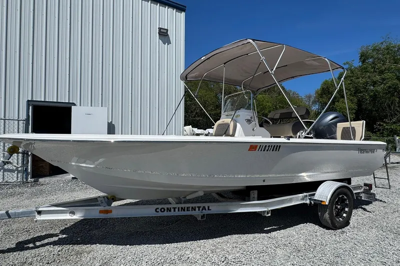 The Image of 2018 Tidewater 1910 Bay Max boat on trailer, parked outside a metal building. - 0