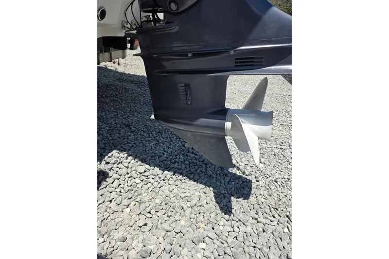 Slide: The Image of Outboard motor propeller of 2018 Tidewater 1910 Bay Max on gravel surface. - 13