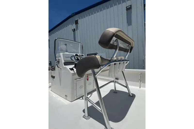 Slide: The Image of 2018 Tidewater 1910 Bay Max boat console and seating, with a blue building backdrop. - 5