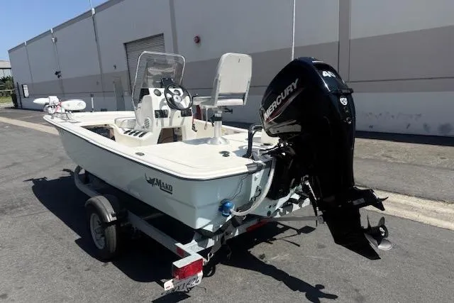 Slide: The Image of 2024 Mako Pro Skiff 13 CC boat with Mercury engine on trailer. - 10