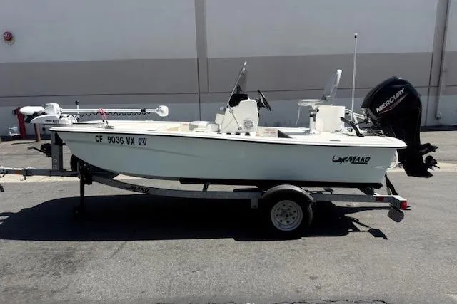 Slide: The Image of 2024 Mako Pro Skiff 13 CC boat on trailer, parked outdoors. - 13