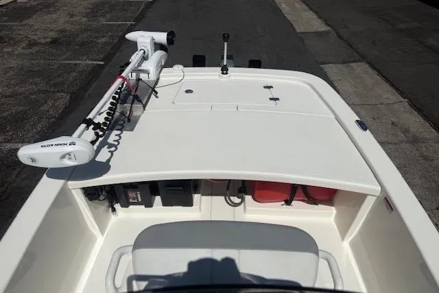 Slide: The Image of 2024 Mako Pro Skiff 13 CC boat deck with trolling motor and storage compartments. - 14