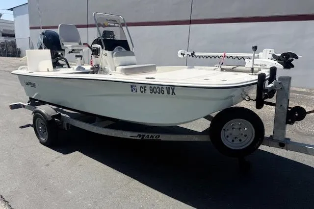 Slide: The Image of 2024 Mako Pro Skiff 13 CC boat on trailer, parked outdoors. - 15