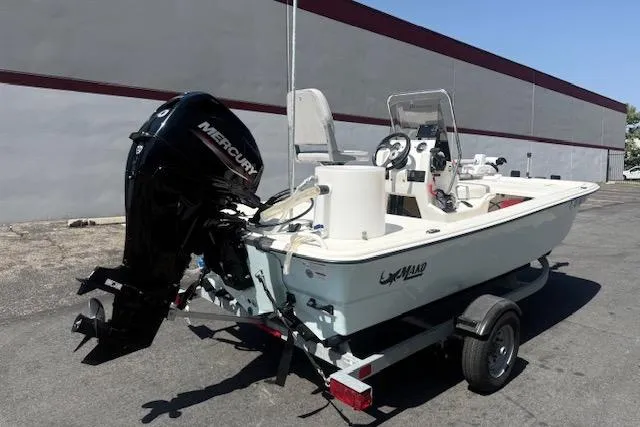 Slide: The Image of 2024 Mako Pro Skiff 13 CC boat on trailer with Mercury outboard motor. - 16