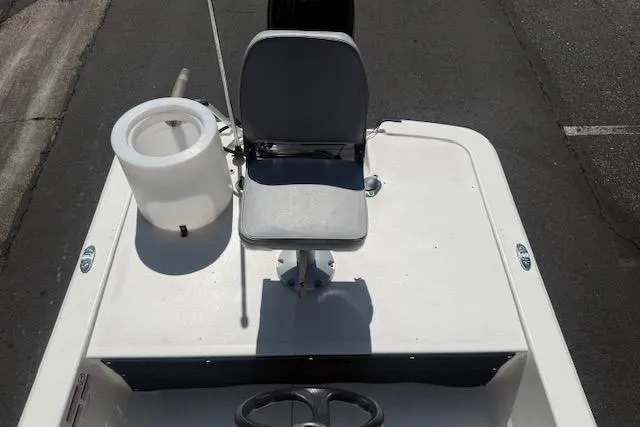 Slide: The Image of 2024 Mako Pro Skiff 13 CC boat interior with seat and steering wheel. - 8