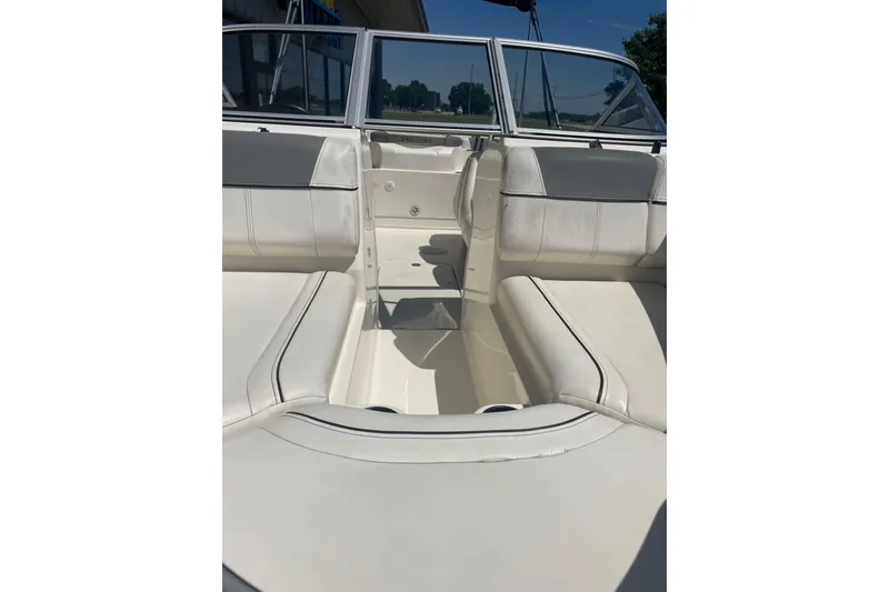 Slide: The Image of 2015 Bayliner 185 Bowrider interior with white seating and open bow area. - 10