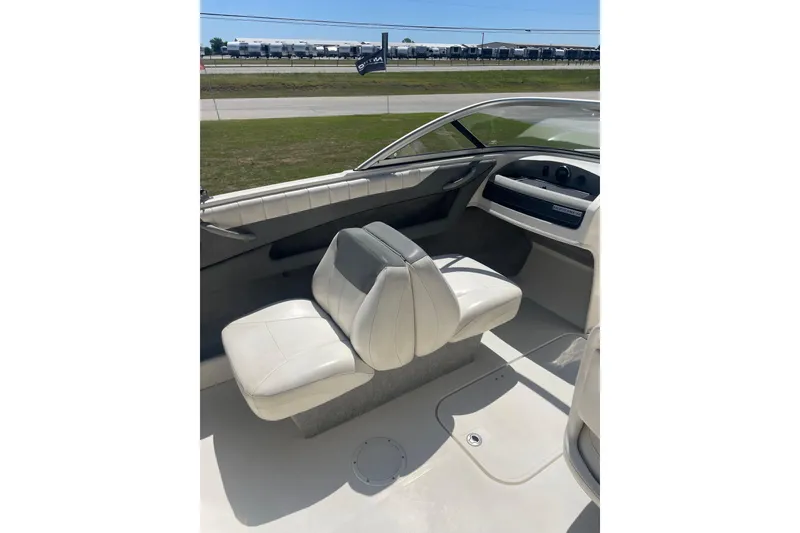 Slide: The Image of 2015 Bayliner 185 Bowrider interior with white seating and dashboard view. - 4