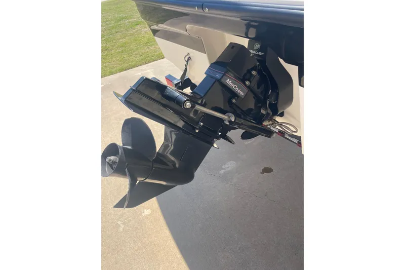 Slide: The Image of 2015 Bayliner 185 Bowrider with MerCruiser outboard motor, parked on concrete surface. - 5