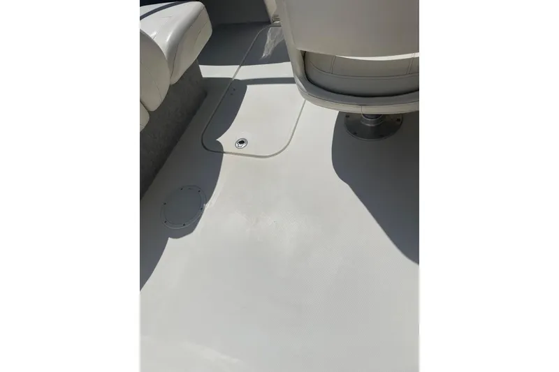 Slide: The Image of Interior view of 2015 Bayliner 185 Bowrider boat, featuring clean white seating and flooring. - 8