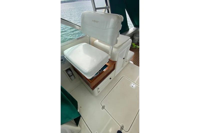 Slide: The Image of Captain's seat on 2001 Pursuit 3000 Express boat, overlooking water. - 5