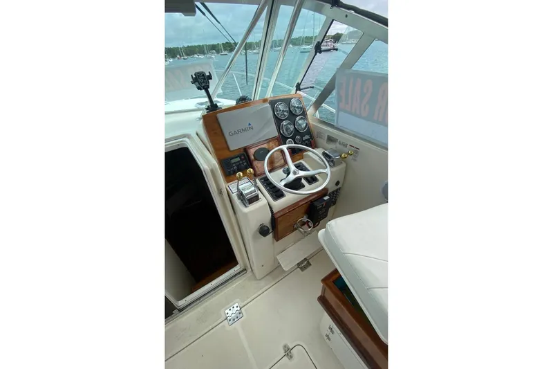 Slide: The Image of 2001 Pursuit 3000 Express boat cockpit with Garmin navigation system and steering wheel. - 7