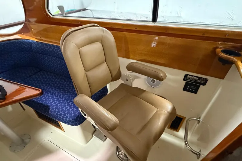 Slide: The Image of Interior of 2003 Hinckley Picnic Boat 36 EP with leather seat and blue cushioned bench. - 3
