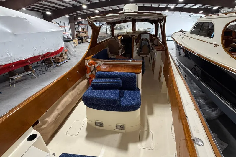 Slide: The Image of 2003 Hinckley Picnic Boat 36 EP interior with blue seating in a storage facility. - 6