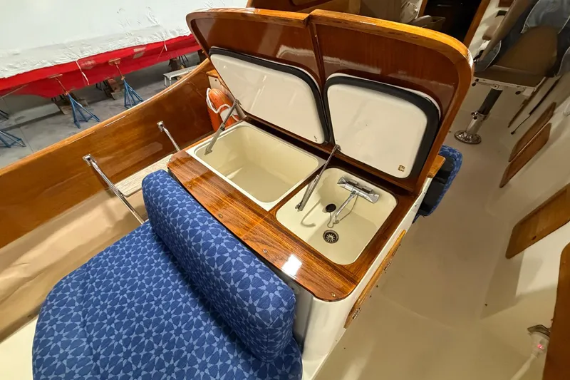 Slide: The Image of 2003 Hinckley Picnic Boat 36 EP interior with sink and storage compartments. - 7