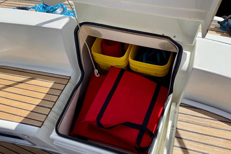 Slide: The Image of Storage compartment on 2004 Jeanneau Sun Odyssey 35 sailboat with safety gear and equipment. - 11