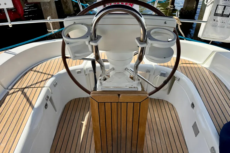 Slide: The Image of Steering wheel of 2004 Jeanneau Sun Odyssey 35 sailboat with wooden deck. - 17