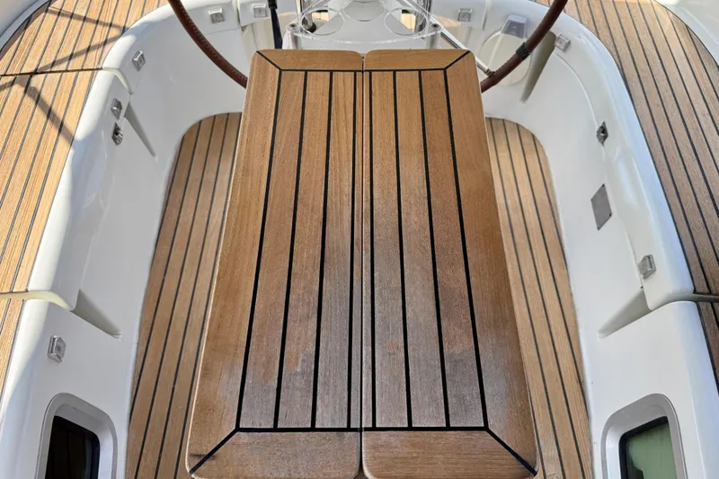 Slide: The Image of Cockpit of 2004 Jeanneau Sun Odyssey 35 with wooden table and seating. - 18