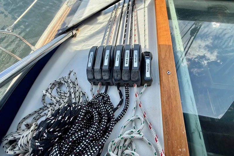 Slide: The Image of Rope clutches and lines on a 2004 Jeanneau Sun Odyssey 35 sailboat deck. - 22