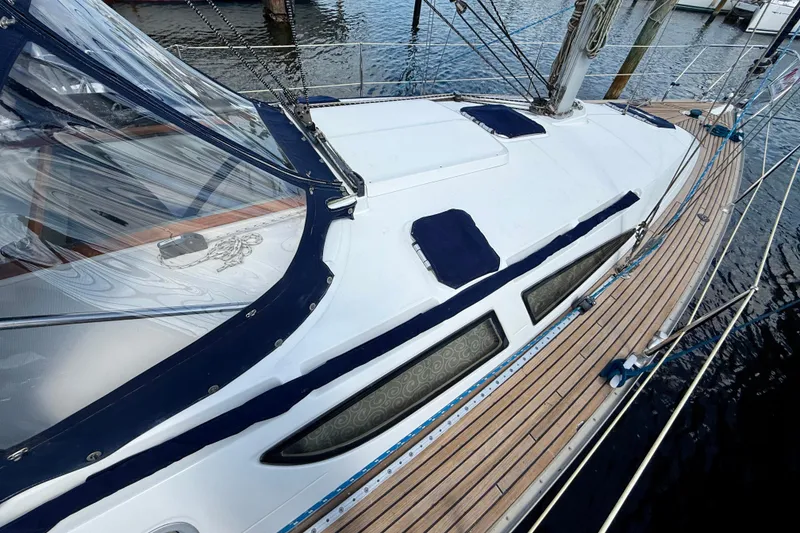 Slide: The Image of 2004 Jeanneau Sun Odyssey 35 sailboat with sleek deck design and blue accents. - 24