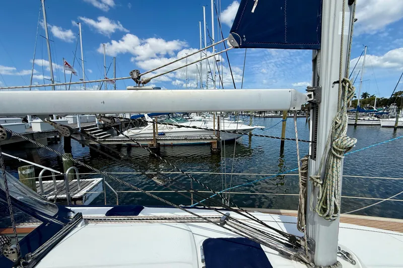 Slide: The Image of 2004 Jeanneau Sun Odyssey 35 sailboat docked at marina, clear sky, calm water. - 27