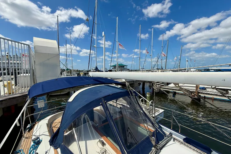 Slide: The Image of 2004 Jeanneau Sun Odyssey 35 sailboat docked at marina under blue sky. - 28