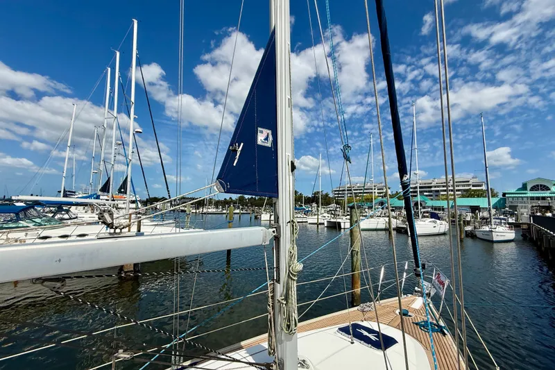 Slide: The Image of 2004 Jeanneau Sun Odyssey 35 sailboat docked in a marina under a clear blue sky. - 29