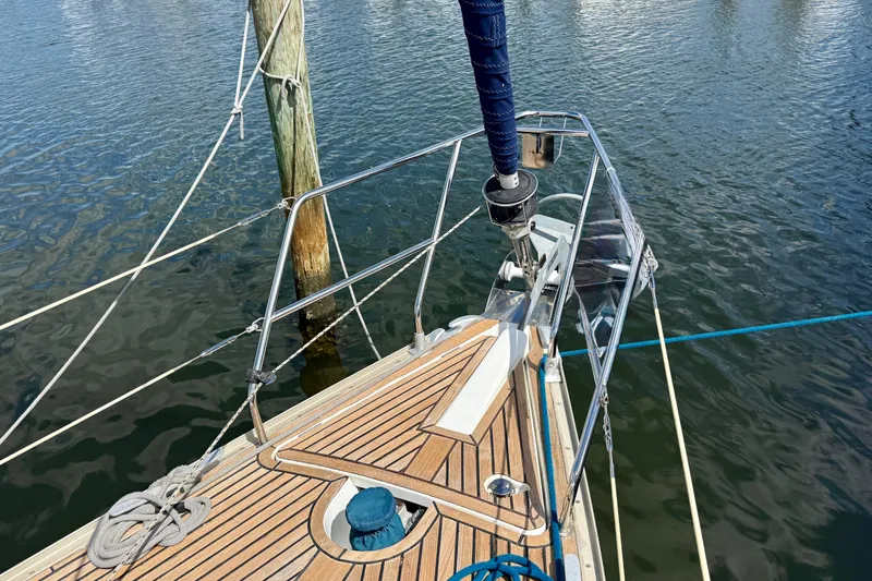Slide: The Image of Bow of 2004 Jeanneau Sun Odyssey 35 sailboat with teak deck and mooring lines. - 30