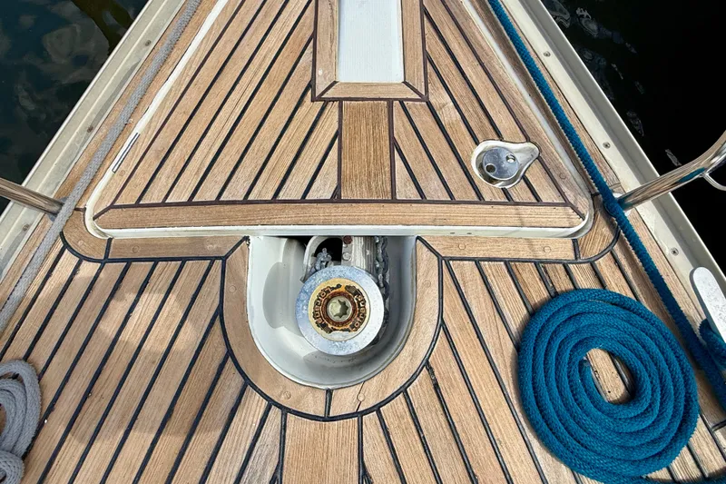 Slide: The Image of Deck of 2004 Jeanneau Sun Odyssey 35 sailboat with teak finish and coiled rope. - 34