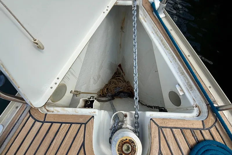 Slide: The Image of Anchor locker of 2004 Jeanneau Sun Odyssey 35 sailboat with chain and rope. - 35