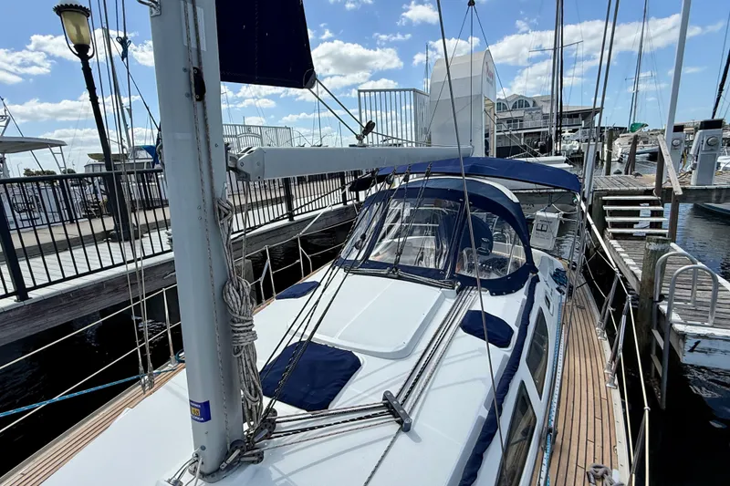 Slide: The Image of 2004 Jeanneau Sun Odyssey 35 sailboat docked at marina under clear blue sky. - 37