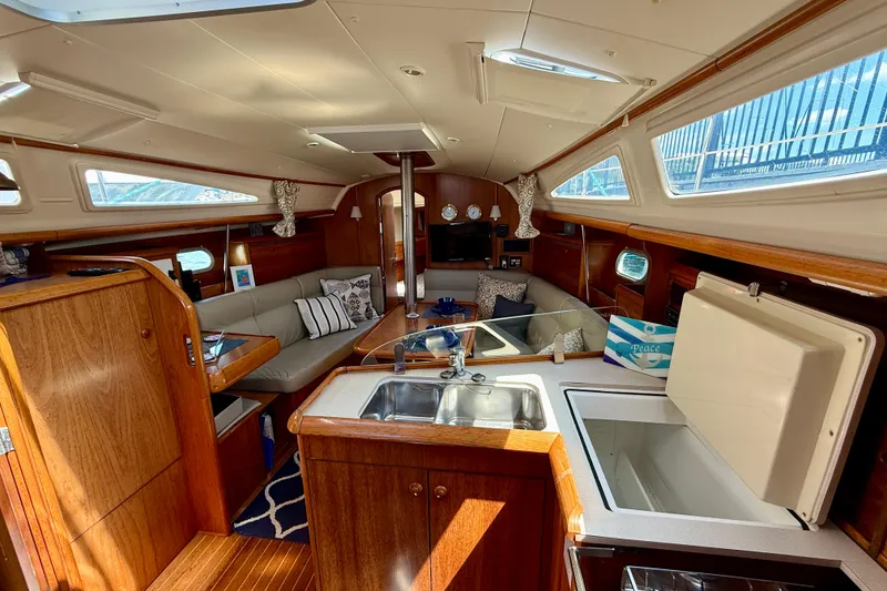 Slide: The Image of Interior of 2004 Jeanneau Sun Odyssey 35 sailboat with cozy seating and kitchenette. - 40