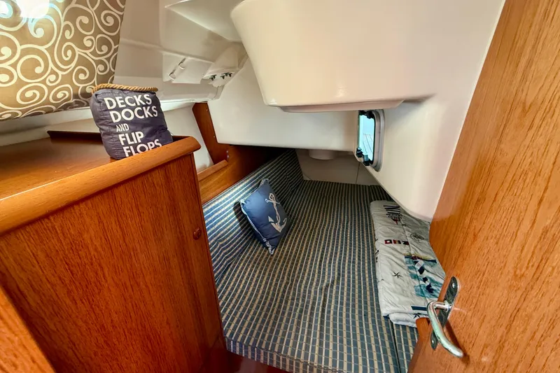 Slide: The Image of Cozy cabin interior of 2004 Jeanneau Sun Odyssey 35 sailboat with nautical decor. - 41