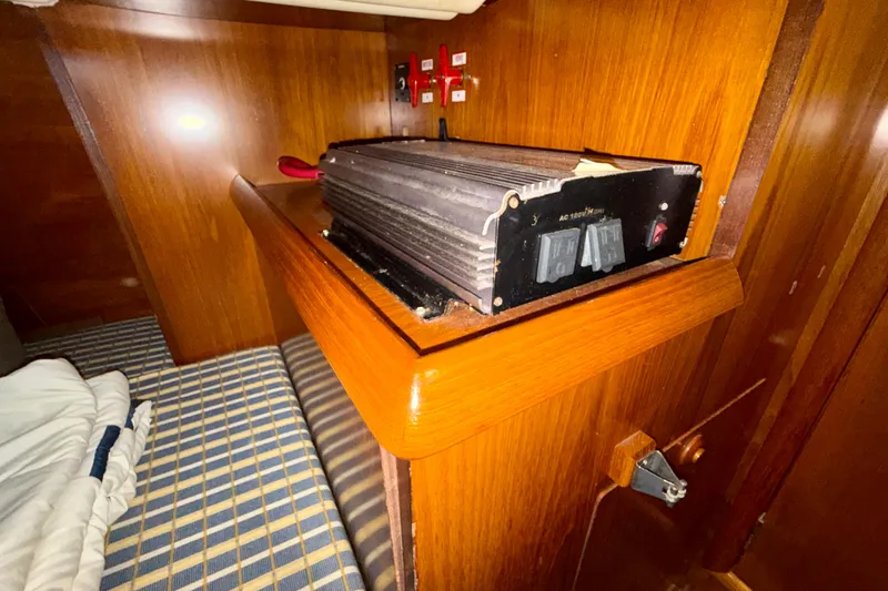 Slide: The Image of Interior of 2004 Jeanneau Sun Odyssey 35 yacht with electrical equipment on wooden shelf. - 44
